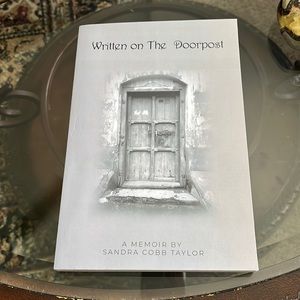 Softcover (Written on the Doorpost by Sandra Cobb Taylor).